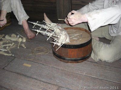 Fig. 1 Presentation of prisoners of war in a hulk building a model bone ship