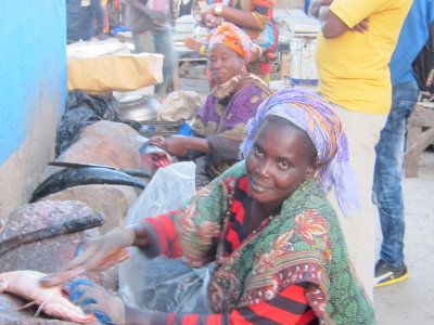 The women scraping the scales off the fish are in an especially vulnerable position